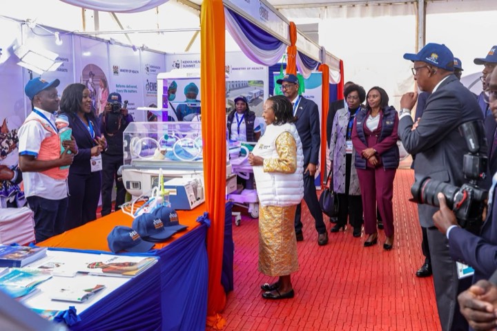 Visitors at an exhibition stand with newborn incubators and EWENE caps