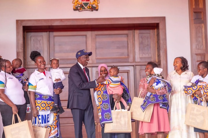 Mothers holding their babies and receiving gift bags at the EWENE launch