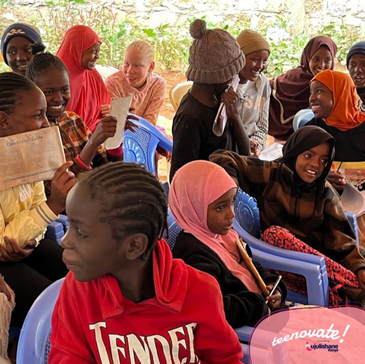 A group of smiling girls seated together during a session
