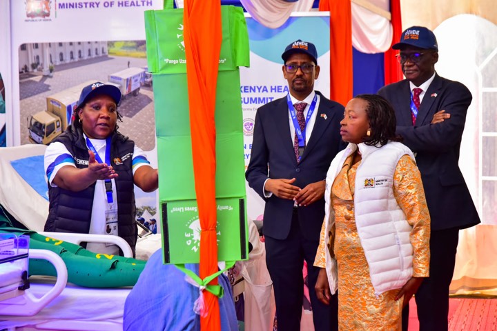Officials looking at newborn care beds and equipment at the exhibition